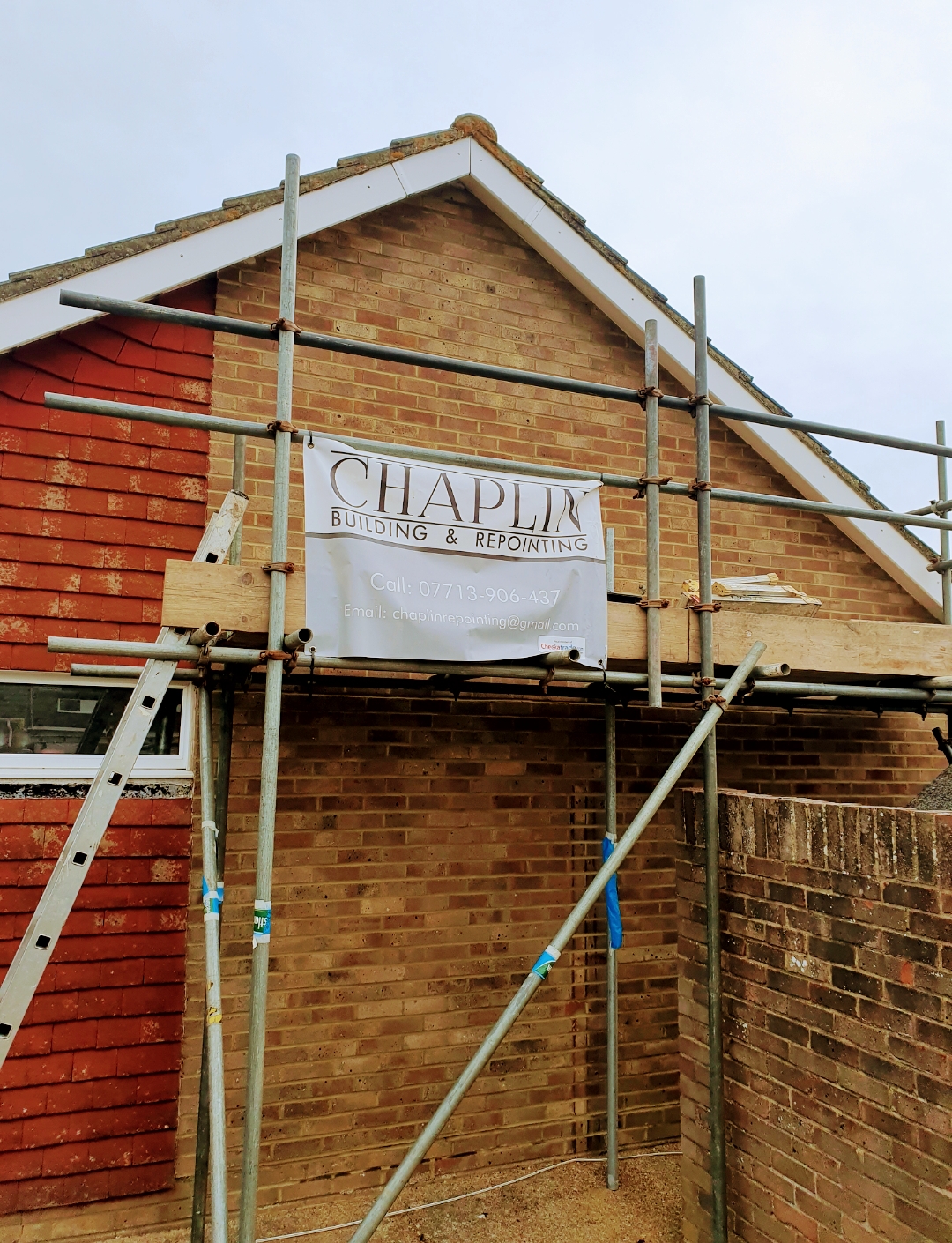 Chaplin Building & Repointing banner on scaffold at a gable end
