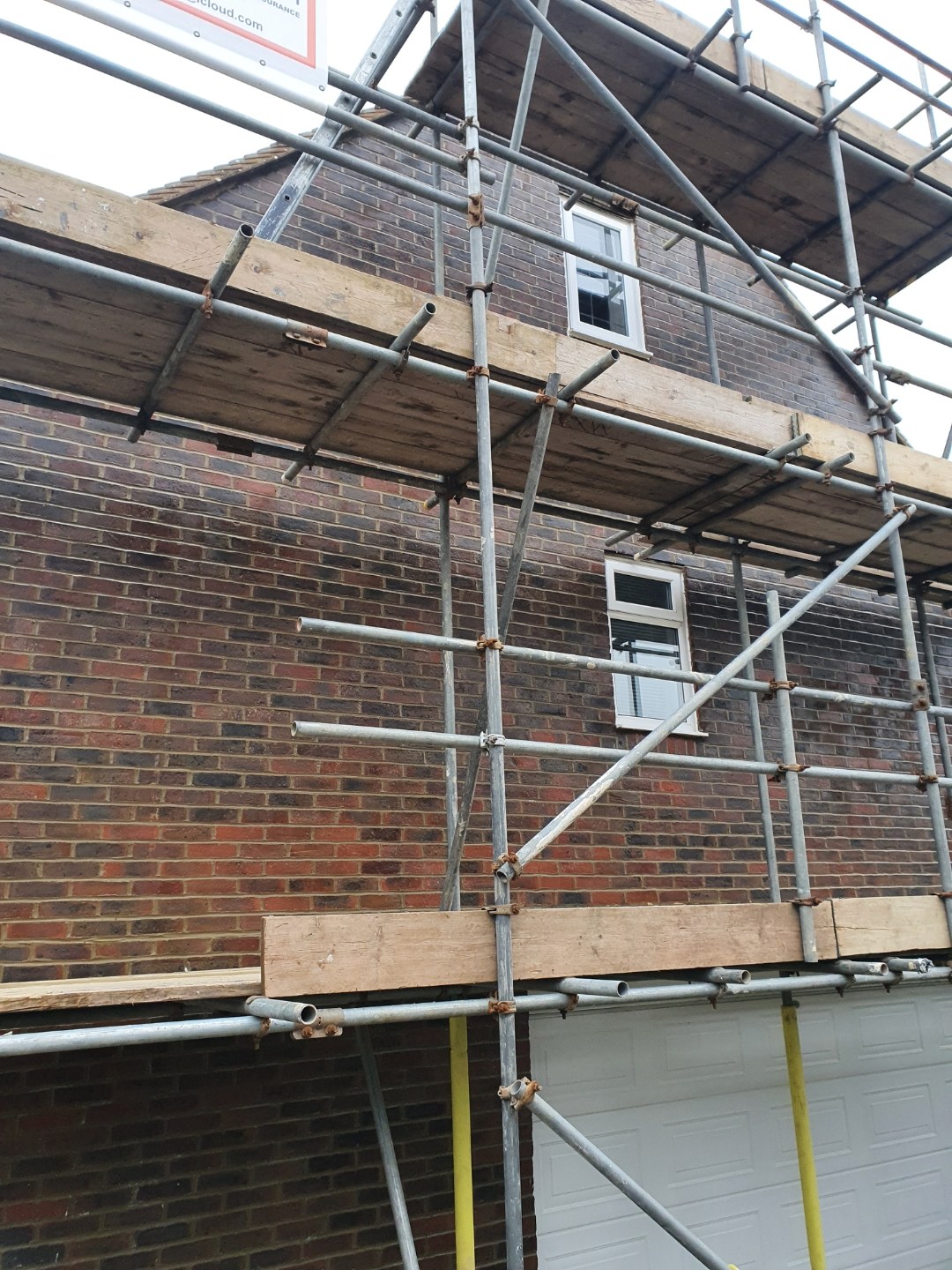 Scaffolding up on a brick house ready for remedial work